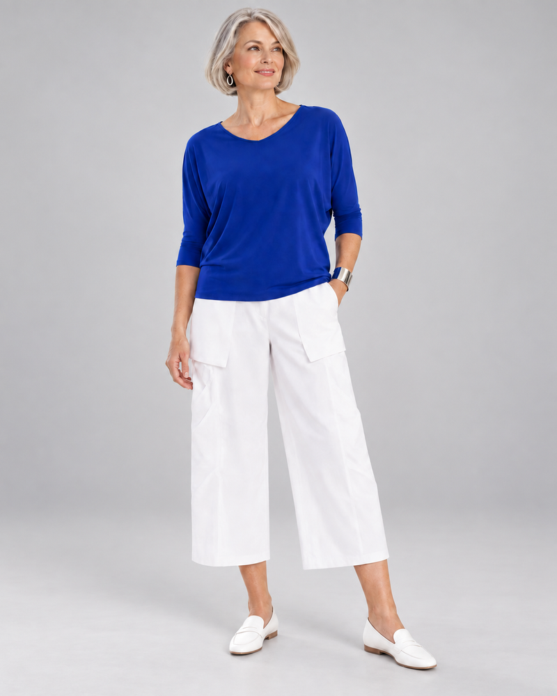 Classic Batwing Top in Santorini Blue with white cropped trousers.